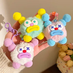 Handheld set of three fuzzy monster keychains with sausage lips in vibrant colors