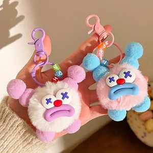 Close-up of cute plush keychains with sausage lips and colorful letter bead charms