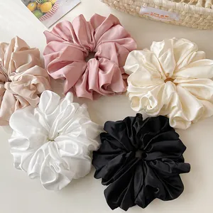 Oversized satin silk scrunchies in champagne, pink, cream, white, and black colors