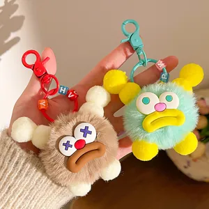 Detail of plush monster keychains with fuzzy texture and colorful letter beads