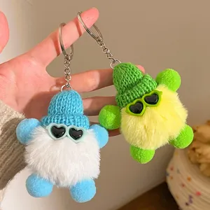 Gros plan de porte-clés peluche avec bonnets en tricot et lunettes de soleil en cœur