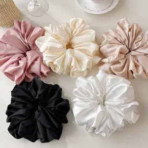 Oversized satin silk scrunchies set in neutral colors for elegant ponytails