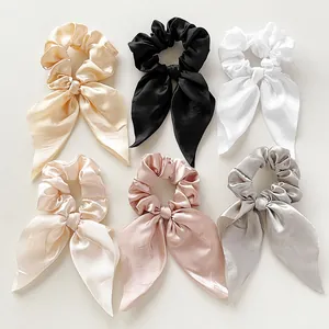 Set of six colorful satin ribbon scrunchies in champagne, black, white, and pastels