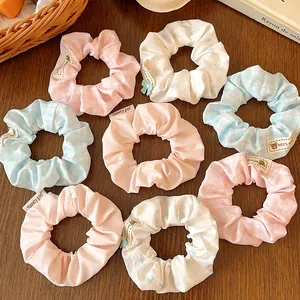 Set of 8 cute blue and pink striped scrunchies for hair buns with floral and plaid patterns