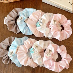 10-piece set of assorted striped and floral scrunchies with cute bear labels for women