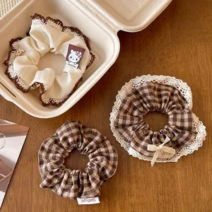 Three-piece checkered hair scrunchie set with lace trim and cute bear mascot tag