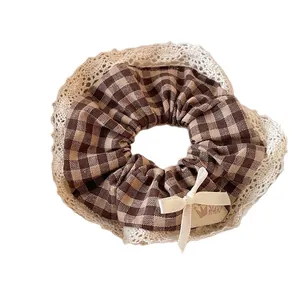 Lace-trimmed plaid scrunchie with ribbon bow and cute bear style leather tag