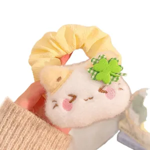 Cute yellow scrunchie with plush cat face and green lucky four-leaf clover design