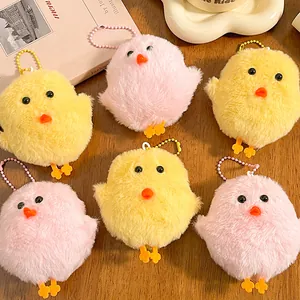 Set of six cute plush chick keychains in pink and yellow on a wooden table decoration