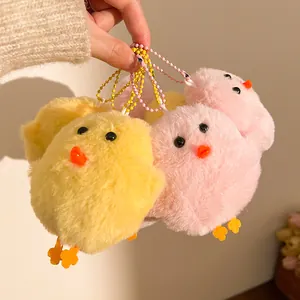 Detail of pink and yellow plush chick keychains with soft faux fur and bead chains