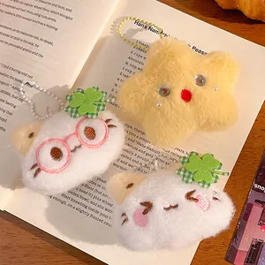 Cute plush cat and star charms with clover details on warm rustic background