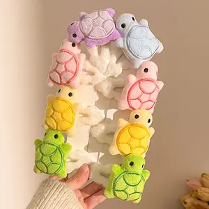 Set of 8 cute plush turtle hair clips in colorful soft fabric shown on display cards