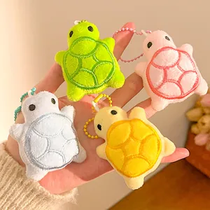 Close-up of colorful plush turtle keychains with soft embroidery and metal ball chains