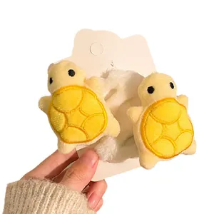Cute yellow plush turtle hair ties on a white card for girls daily hair styling