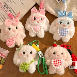 Set of five cute plush lop-eared bunny keychains with colorful bows and accessories