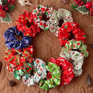 Christmas themed satin hair scrunchies set with festive patterns on brown paper background
