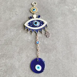 Turkish Blue Evil Eye wall hanging with Hamsa Hand charm for home decor on grey stone