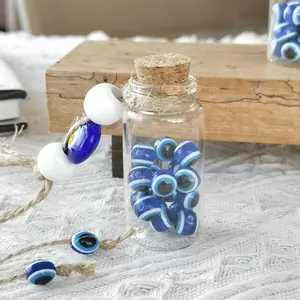 Handmade Turkish evil eye glass bottle charm with cork stopper and rustic jute rope hanging