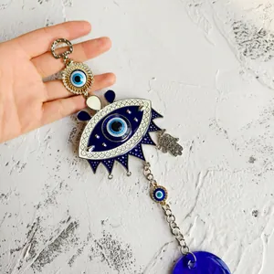 Detail of Turkish blue evil eye wall hanging ornament with Hamsa hand and resin ball