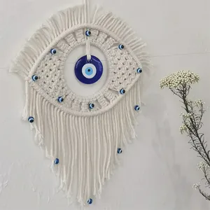 Handmade macrame evil eye wall hanging with blue beads and bohemian fringe decor
