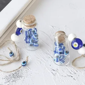 Detail view of small glass bottles filled with blue Turkish Evil Eye beads and jute rope ties