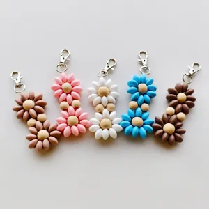 Detailed macro of colorful beaded flower keychains with matte texture and wood beads