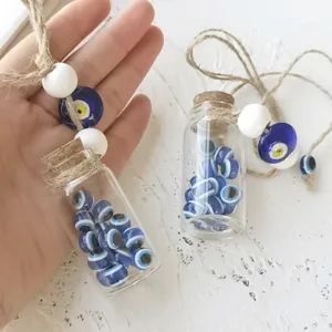 Close-up of Turkish evil eye beads inside a mini glass bottle with natural cork and jute rope