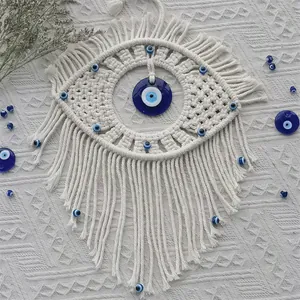 Detail of handmade macramé wall hanging with Turkish evil eye beads and cotton tassels
