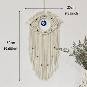 Handmade macrame evil eye wall hanging with bohemian cotton tassels and blue beads