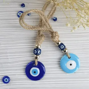 Detail of Turkish Evil Eye charms with glass pendants, gold beads and hemp rope hanging