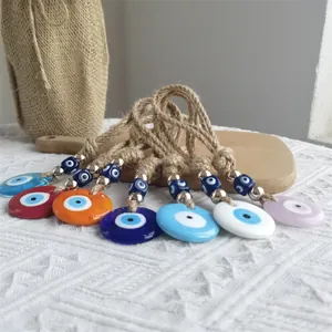 Detailed view of evil eye charms with brown jute rope and silver metal beads decoration