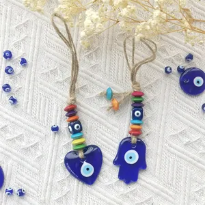 Blue Evil Eye charms with heart and Hamsa Hand shapes on woven ropes for wall decor