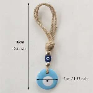 Blue Turkish evil eye hanging ornament with golden beads and jute rope for home decor