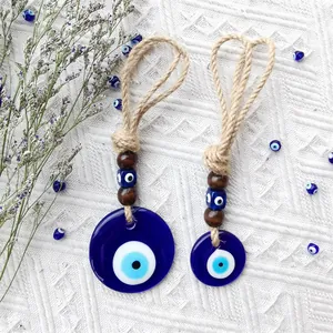 Close-up of handmade Turkish evil eye wall hanging with wooden beads and jute rope