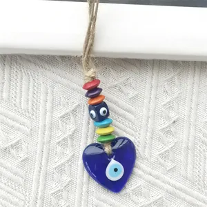 Detailed close-up of a heart-shaped blue evil eye hanging charm with colorful beads