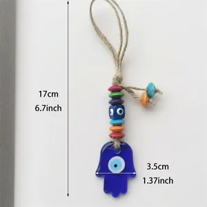 Detail view showing dimensions of Hamsa Hand and Evil Eye glass ornament with beads