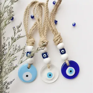 Handgemaakte Evil Eye wanddecoratie set met blauwe glazen bedels en natuurlijke jutetouw