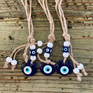Handmade evil eye wall hanging decor with blue glass beads and natural jute rope