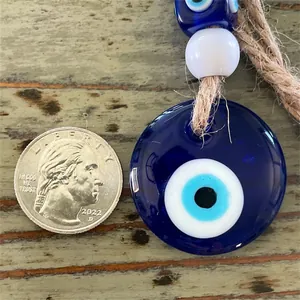 Handmade Evil Eye glass pendant with blue eye design and natural hemp rope hanger