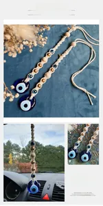 Detail of hand-woven Evil Eye wall hanging with blue glass charm and wooden beads