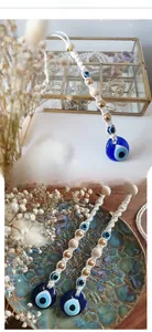 Detailed macro view of handmade macrame Evil Eye wall hanging with blue glass pendant