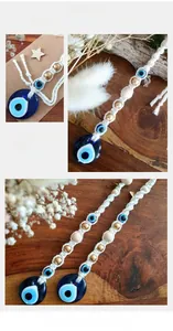 Close-up of handmade Macramé Evil Eye wall decor with blue glass beads and cotton tassels