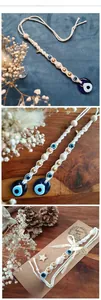 Detailed macro of handmade macrame Evil Eye wall hanging with cotton rope and blue glass bead