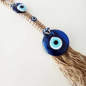 Handmade hemp rope wall hanging with Turkish blue evil eye glass beads and tassels
