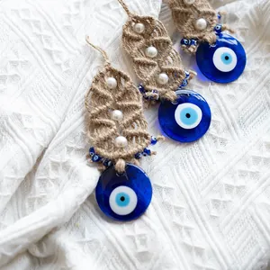 Three handmade Turkish evil eye wall hangings with blue glass and jute leaf decor
