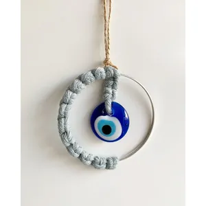 Handcrafted Evil Eye hanging ornament with blue glass pendant and woven cotton rope decor