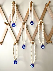 Macro detail of Nordic wood beads and blue glass Evil Eye pendant for car and wall decor