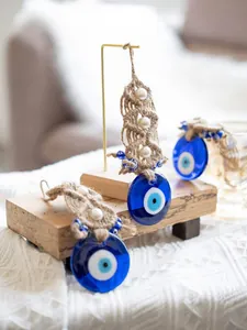 Detailed view of Turkish evil eye wall decor with braided rope and white pearl beads