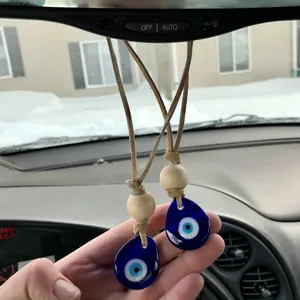 Handmade evil eye car charms with blue glass teardrops and natural wood beads on cords