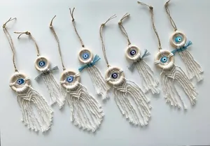 Detail of handcrafted macrame evil eye pendants with wooden rings and cotton tassels